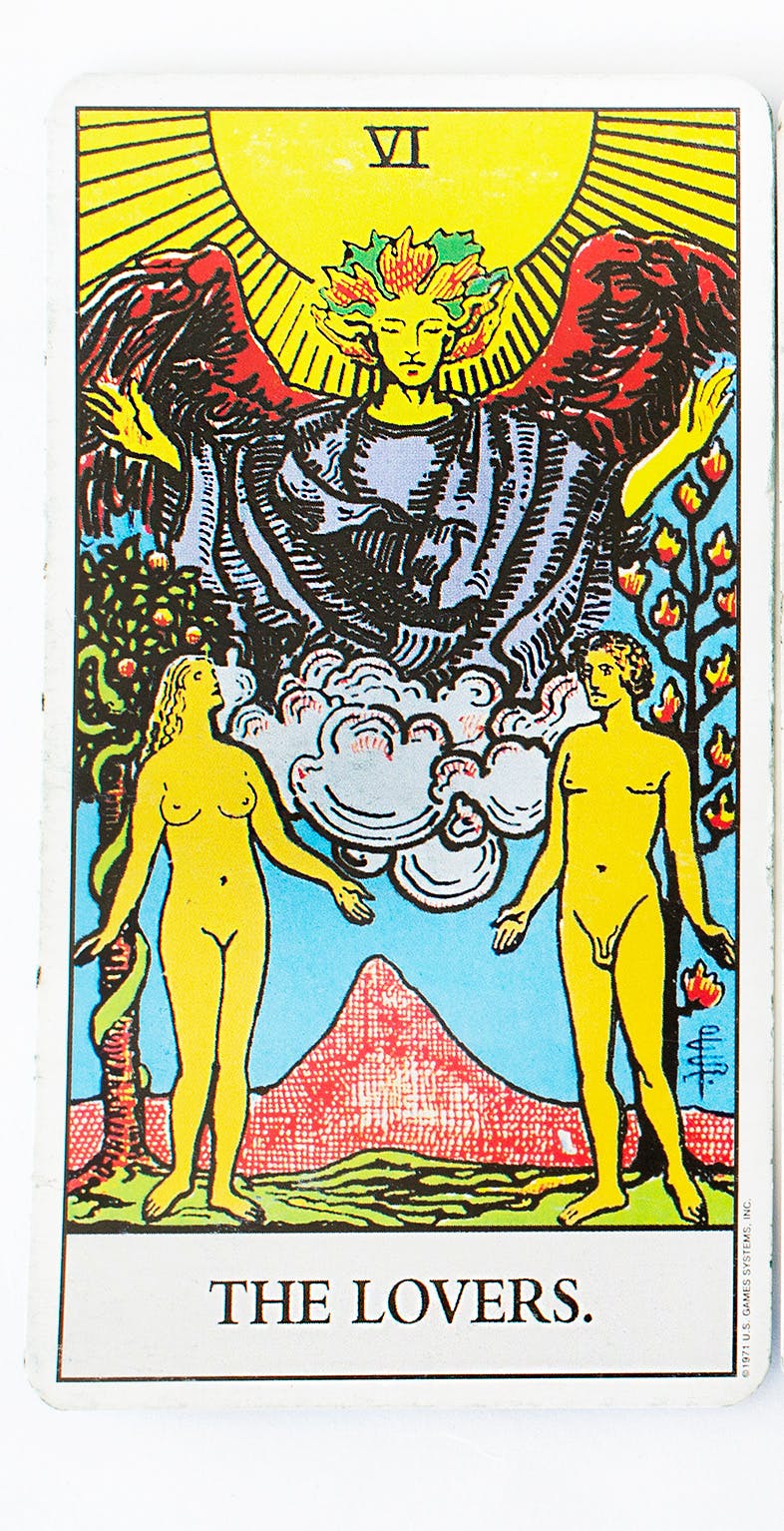 The Lovers tarot card. Features an image of two people naked standing next to each other reaching out as if to hold hands.
