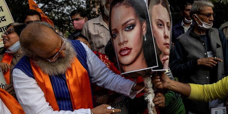 People prepare to burn an effigy of Rihanna and Greta Thunberg