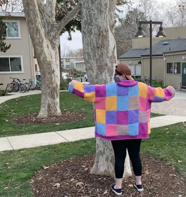 An image of a person showing off their homemade Harry Styles cardigan.