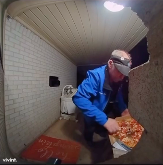 pizza delivery man at customer's front porch touching pizza in box