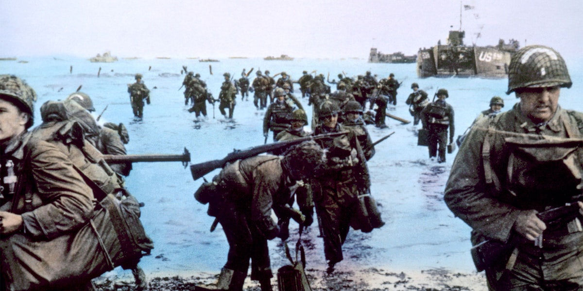 US soldiers enter the beach from the water at The Battle of Normandy, 1944,