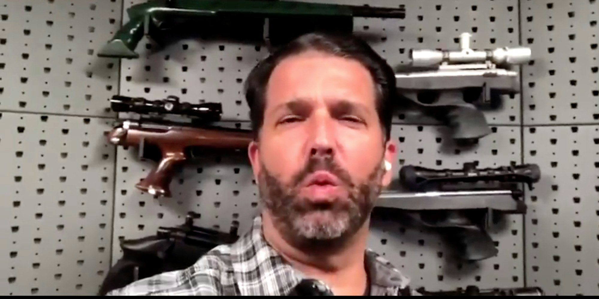 Donald Trump Jr. in front of guns