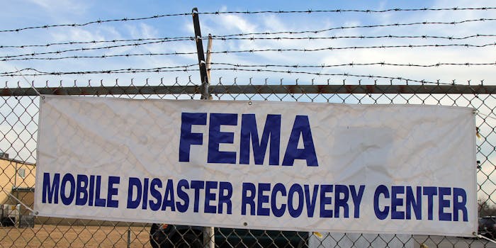 FEMA Mobile disaster recovery center sign on chainlink fence with barbed wire top