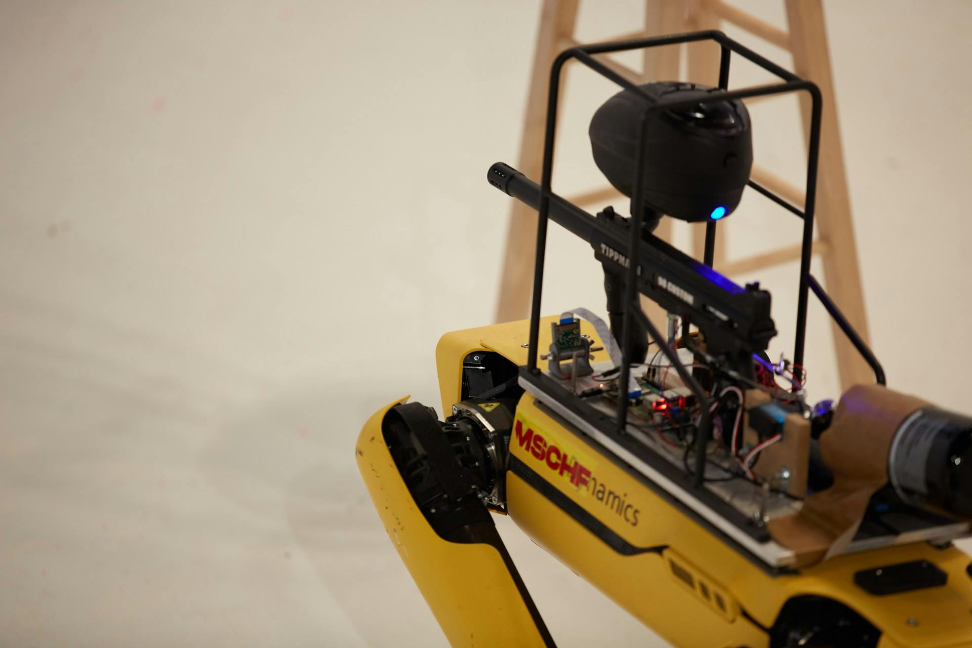 A Spot robot with a paintball gun attached