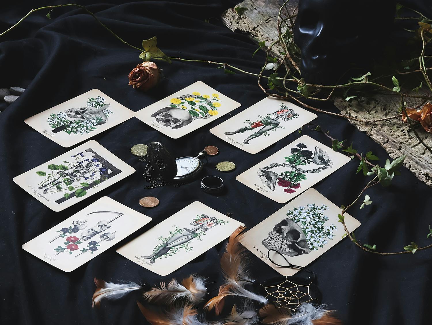 Tarot cards spread on black background with ceramic skull