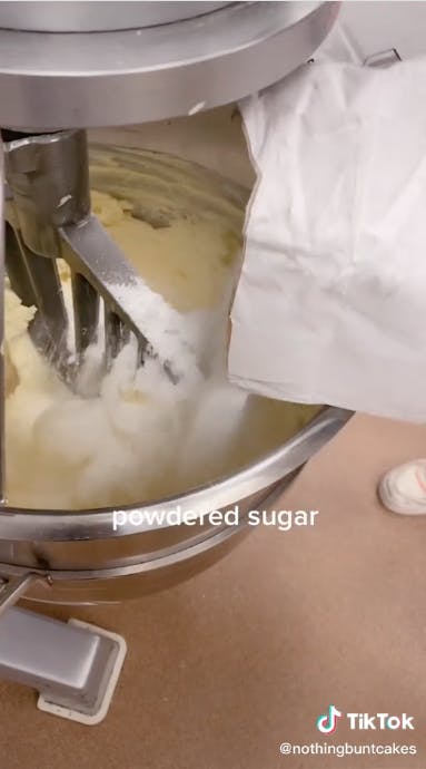 powdered sugar being poured into mixture