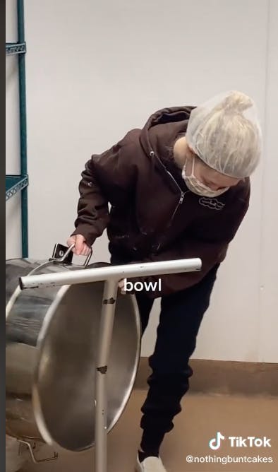 worker holding mixing bowl