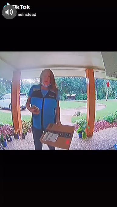 amazon delivery driver with package in hand