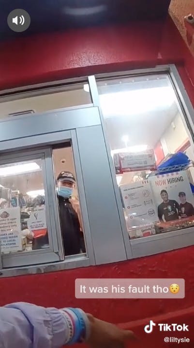 fast food worker at drive-thru window
