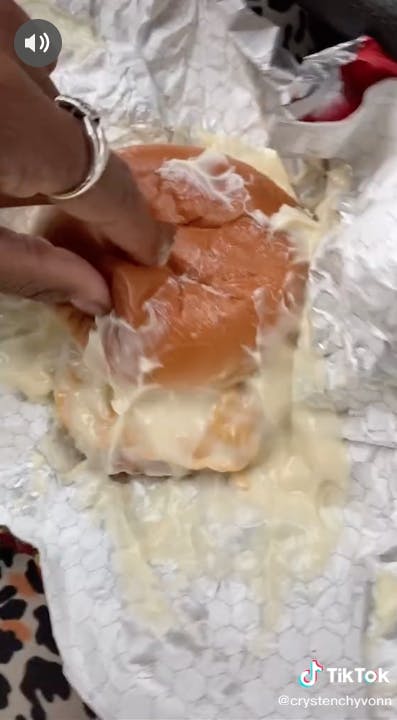 customer touching wendy's sandwich smothered in mayo