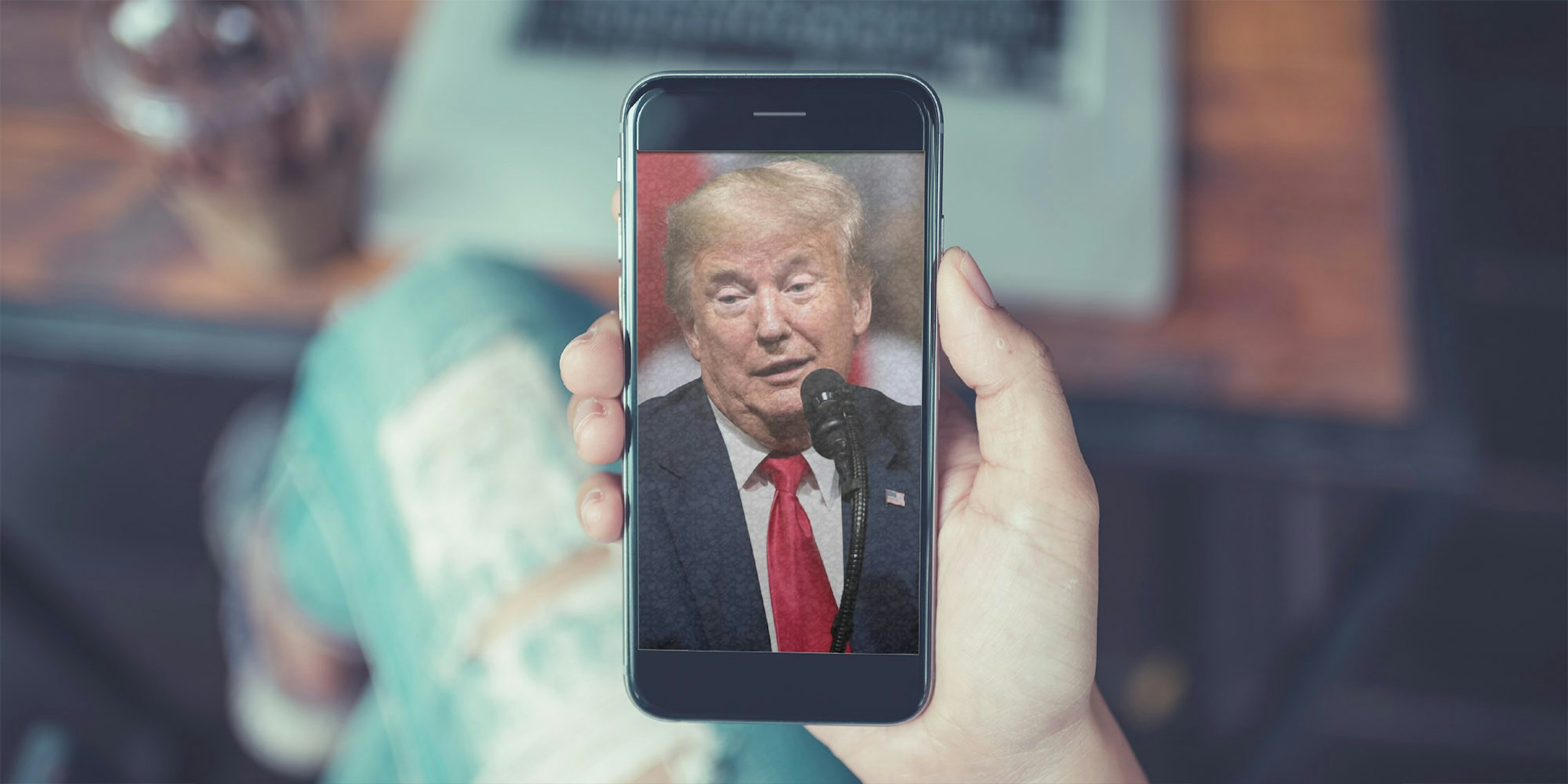 The face of former President Donald Trump on a phone like it would show up when a social media app launches.