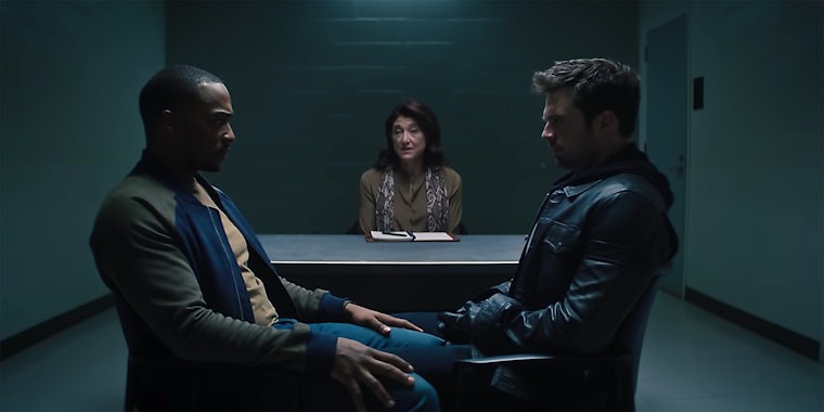 Samuel Thomas Wilson and Bucky Barnes from The Falcon and Winter Soldier stare at each other with a therapist in the background.