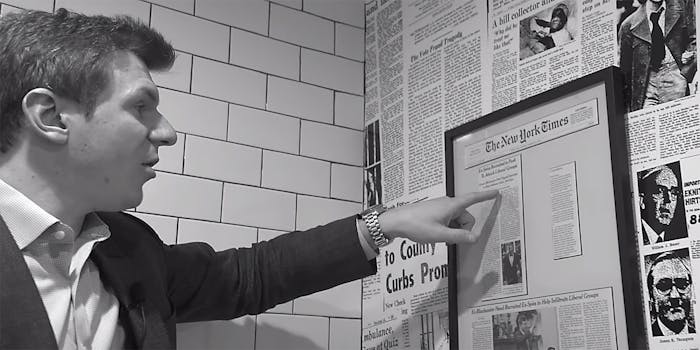 James O'Keefe points at a framed newspaper article.