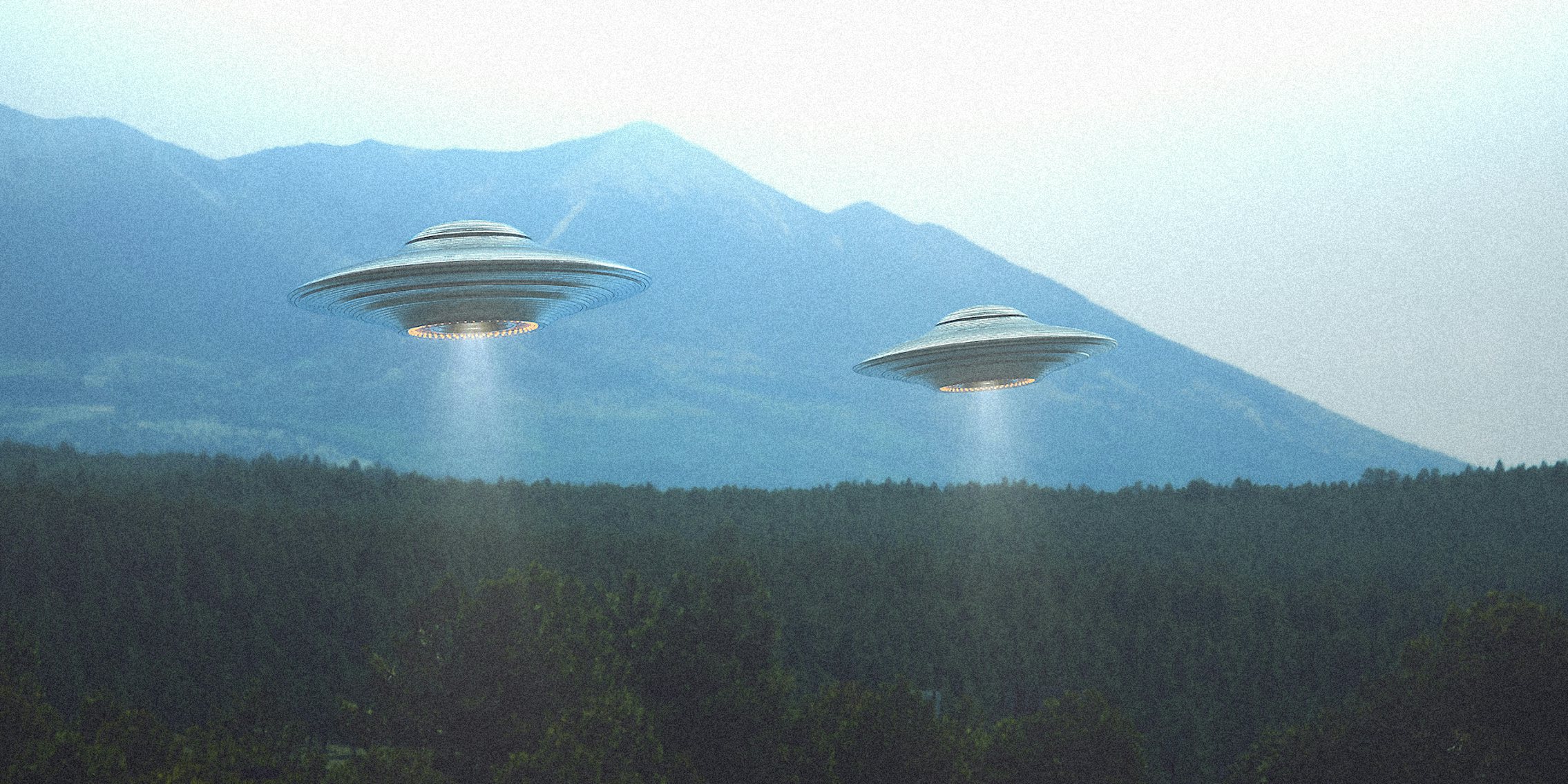 Two UFO ships above forest setting.