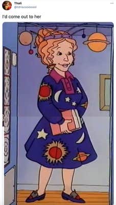 "I'd come out to her" Ms. Frizzle, a cartoon woman with curly red hair in a space patterned dress with a solar system hat