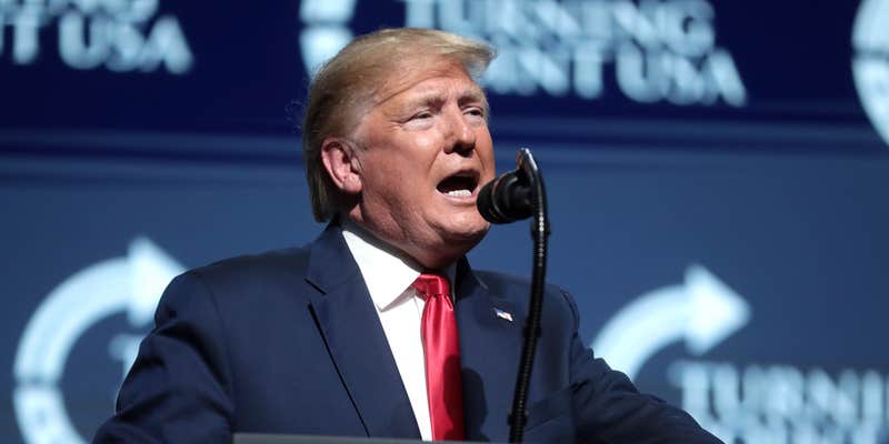 Former President Donald Trump speaking at a podium.