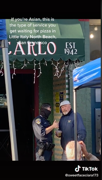 man speaking to police outside of gino and carlo