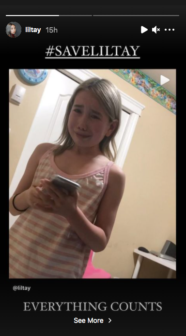 lil tay crying while looking at cellphone