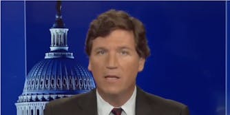A yearbook photo of Tucker Carlson is going viral as it associates him with anti-LGBTQ groups