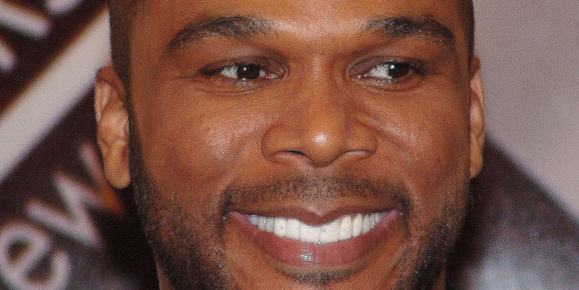 Tyler Perry smiling and looking off camera.