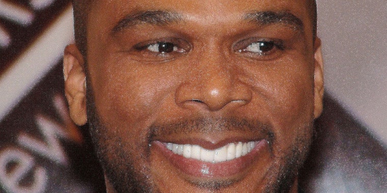 Tyler Perry smiling and looking off camera.