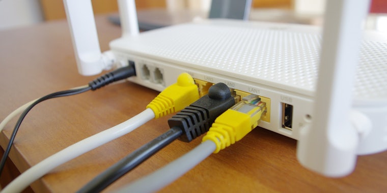 A router that has several broadband ethernet cables plugged into it.