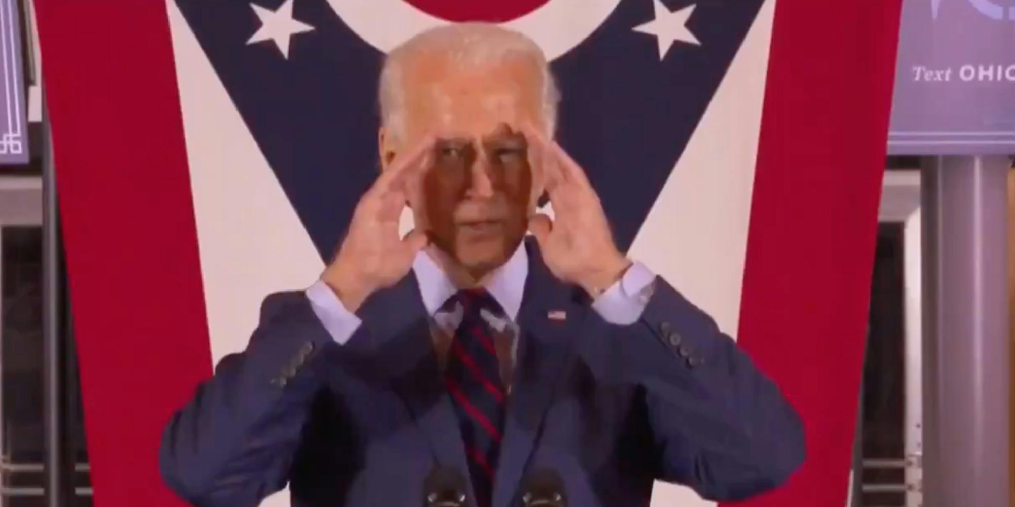 biden speaking with hands in front of face