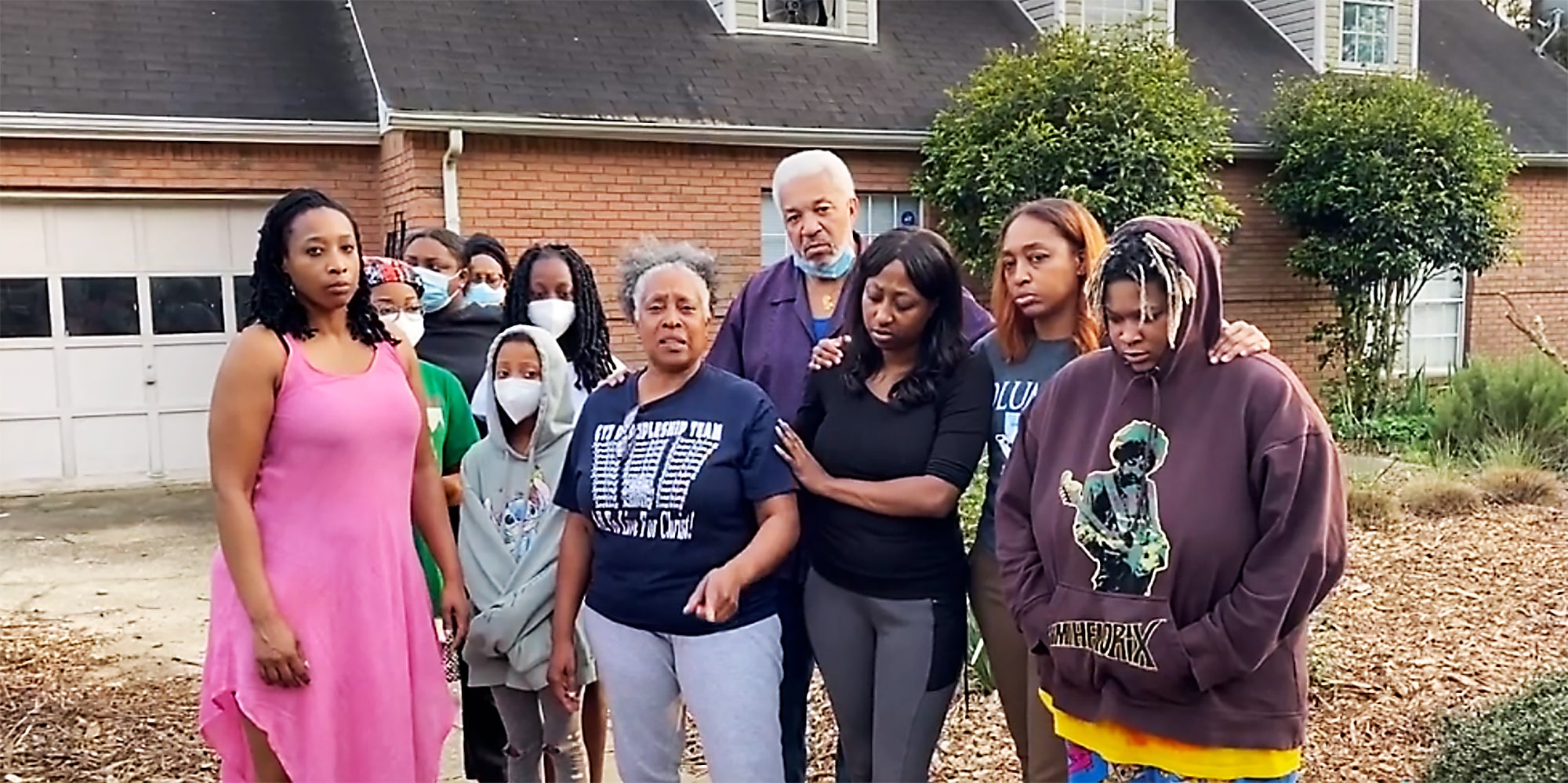 A family in front of their home.