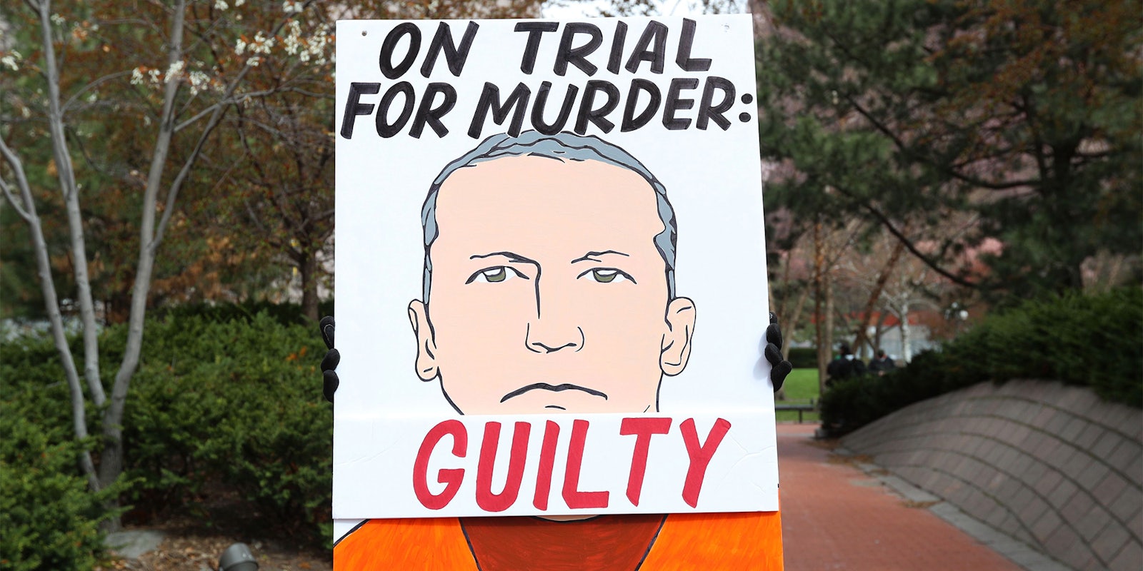 'On trial for murder: Guilty' sign with illustration of Derek Chauvin