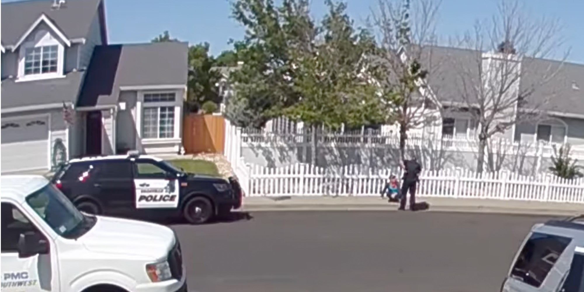 screengrab showing officer over sitting child