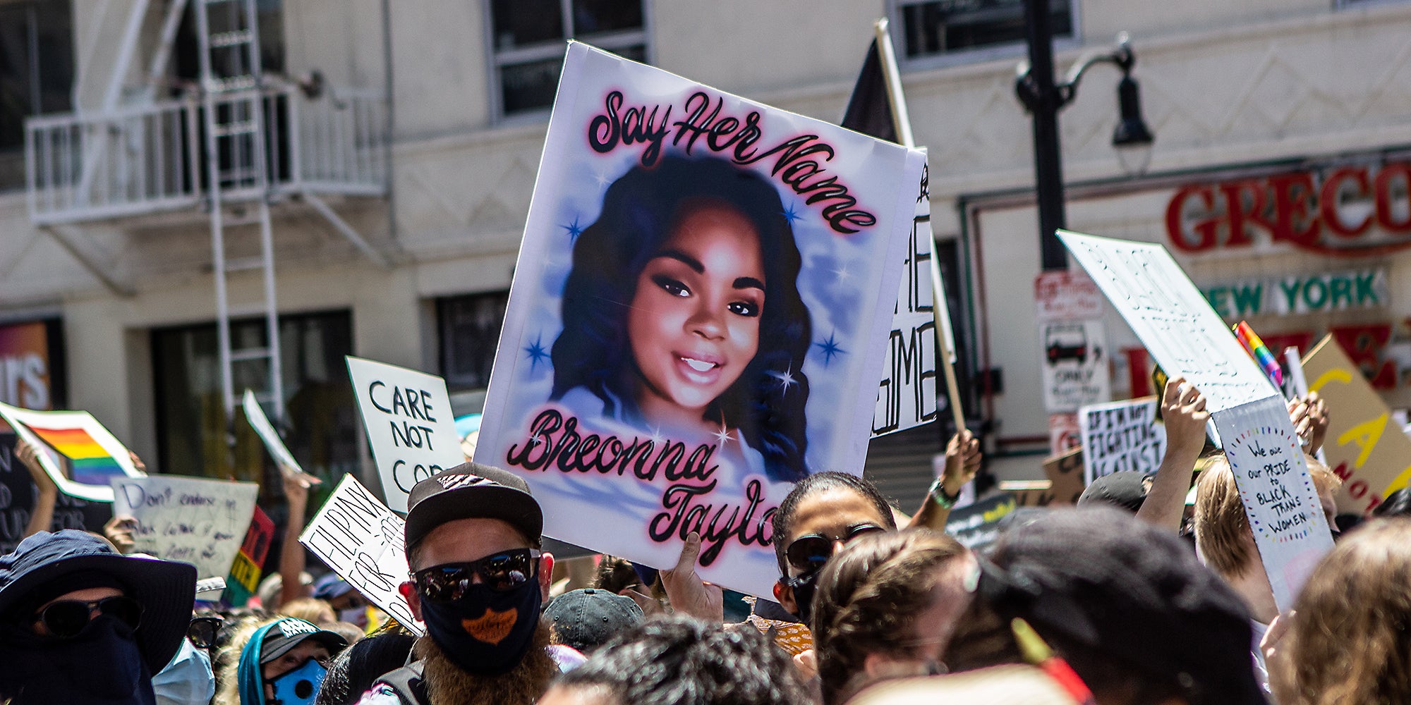 A sign in a crowd that reads, 'Say Her Name Breonna Taylor.'