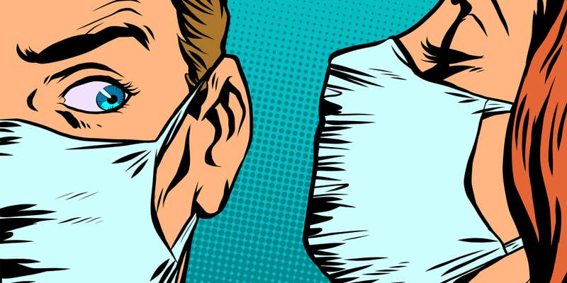 man in mask reacting to woman in mask speaking into his ear