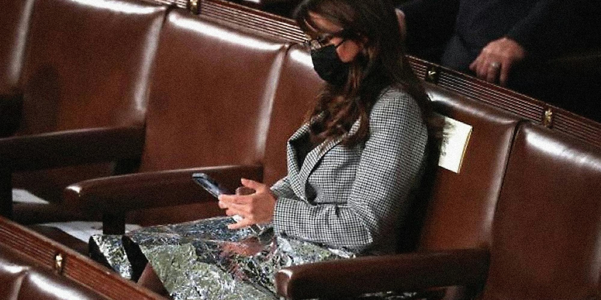 Lauren Boebert with a mylar blanket on her lap.