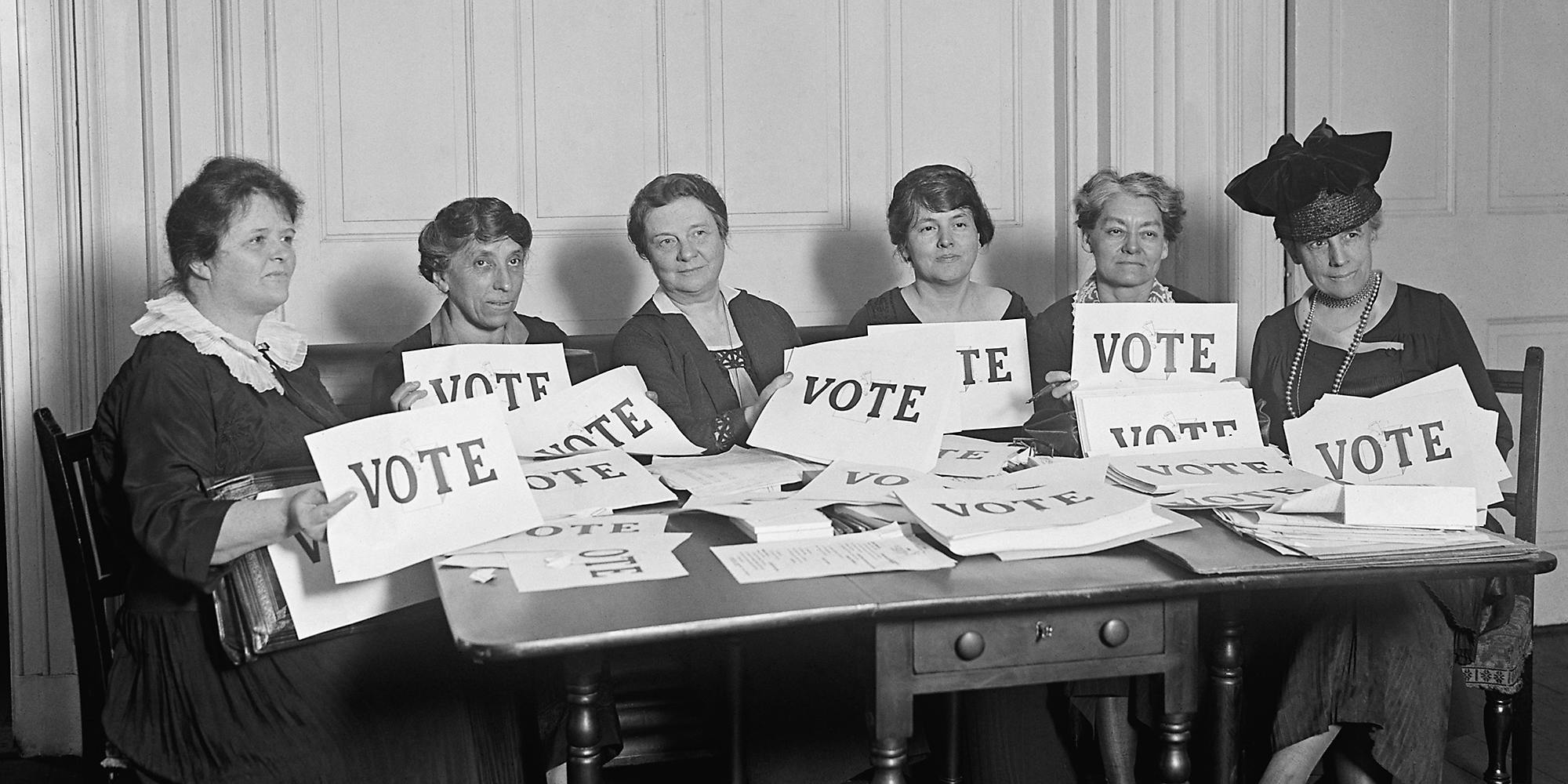 A group of women with 'Vote' signs.