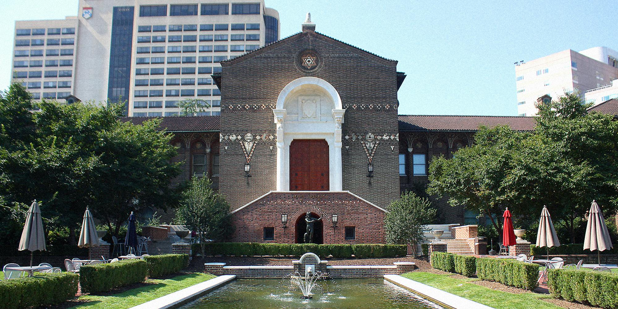 The exterior of a museum with water fountain in foreground.