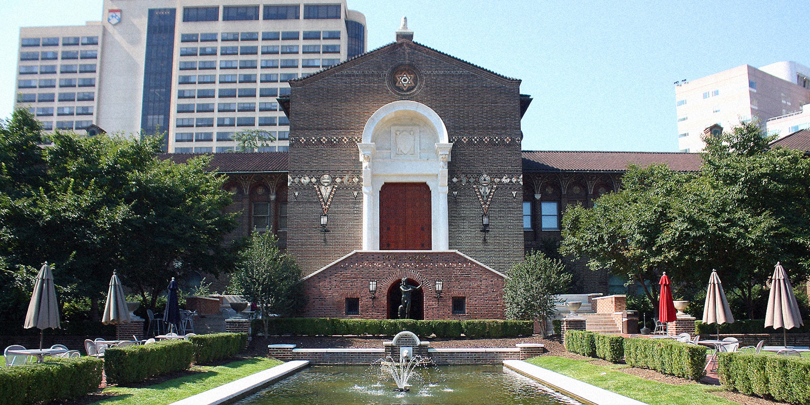 The exterior of a museum with water fountain in foreground.