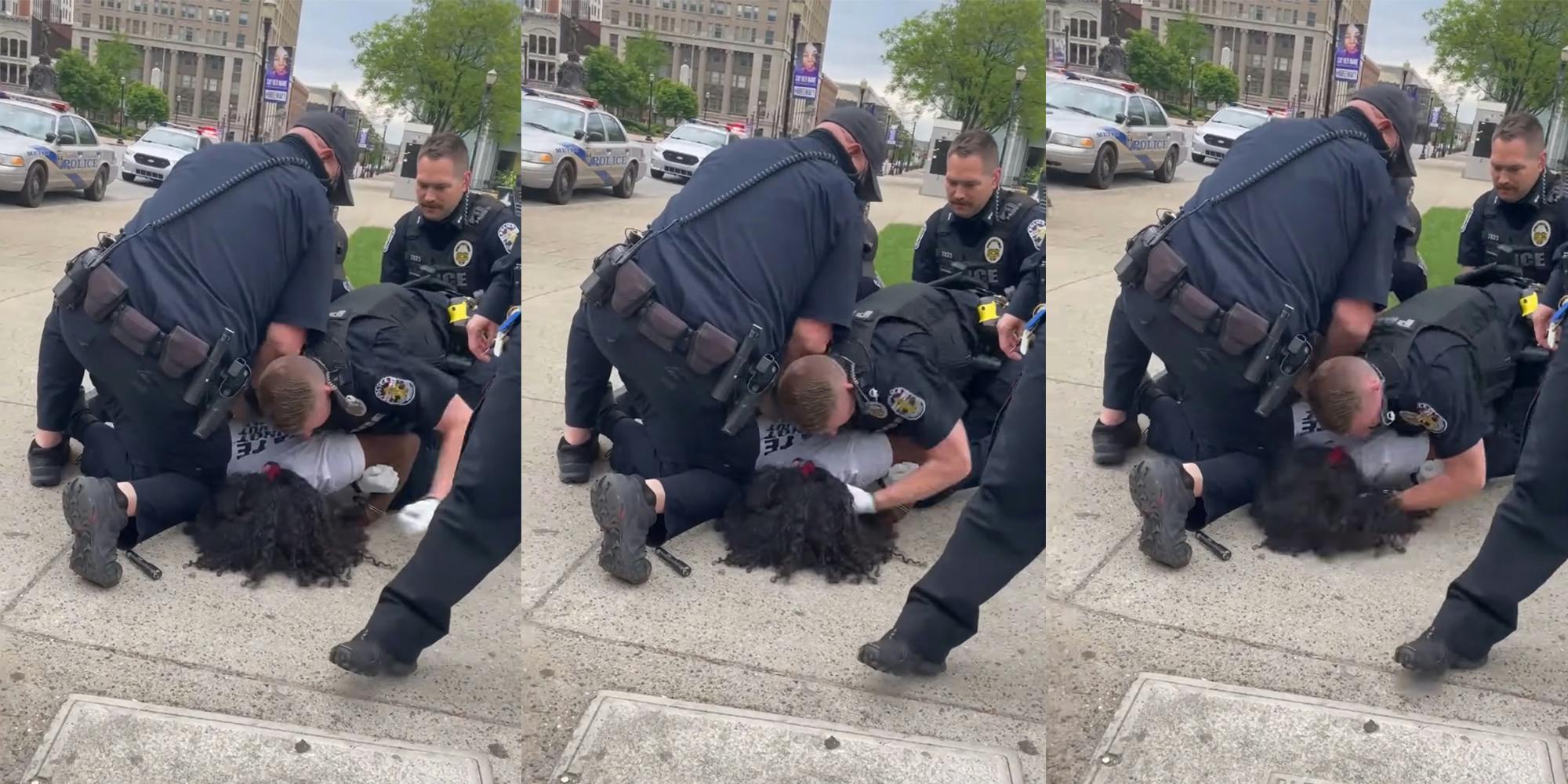 police officer punches man in the head while three other officers hold him down