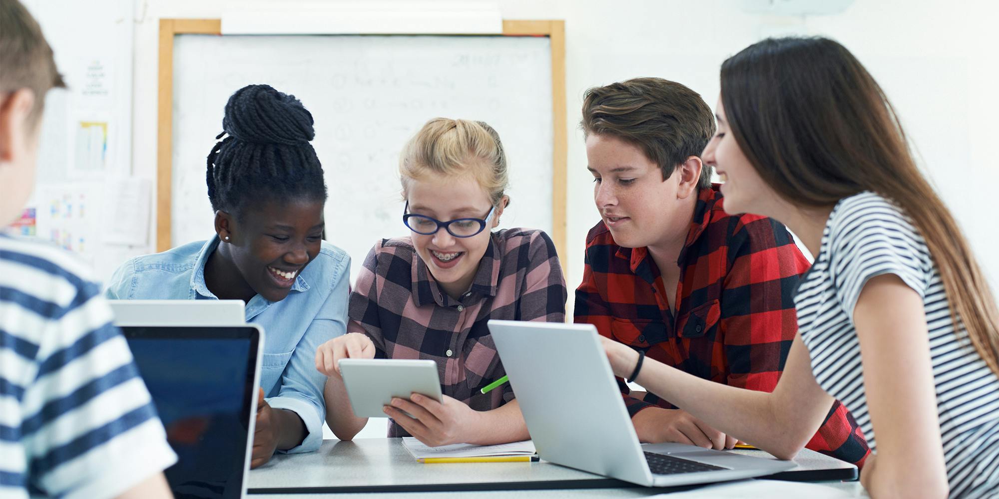 Students at table using devices