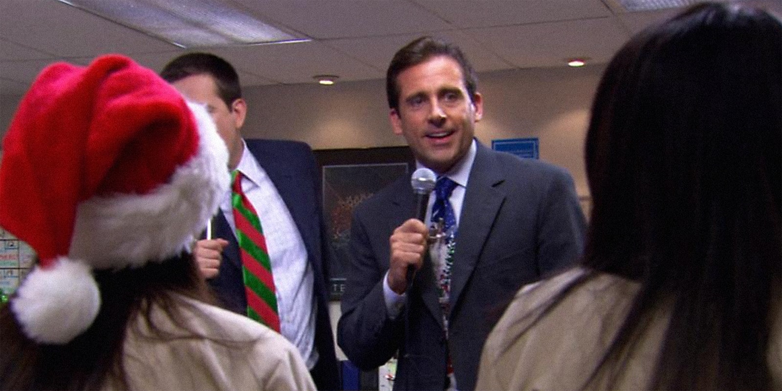Michael Scott (played by Steve Carell) singing into a microphone.