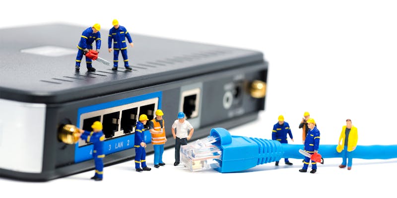  Tiny statues setting up broadband cable television into router