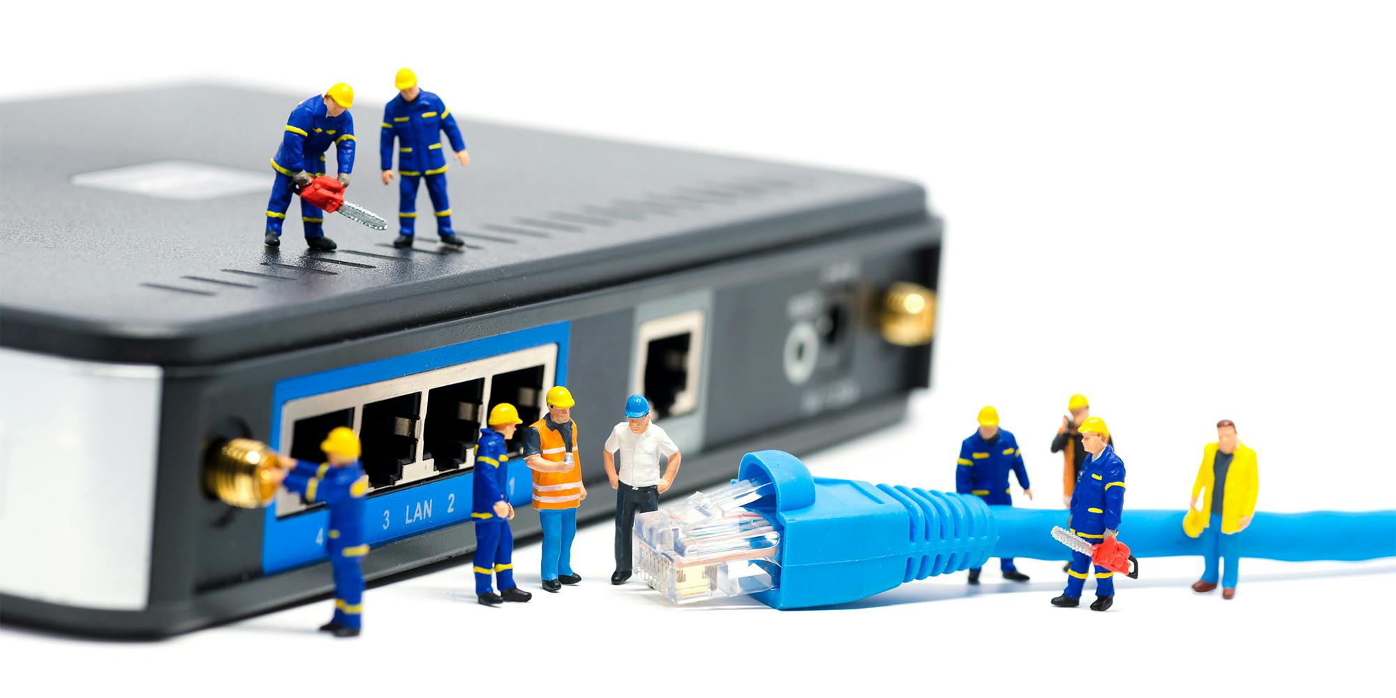 Tiny statues installing broadband cable into router