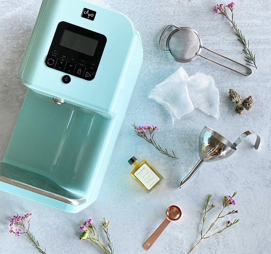 LEVO II device lays next to herbs and measuring spoons