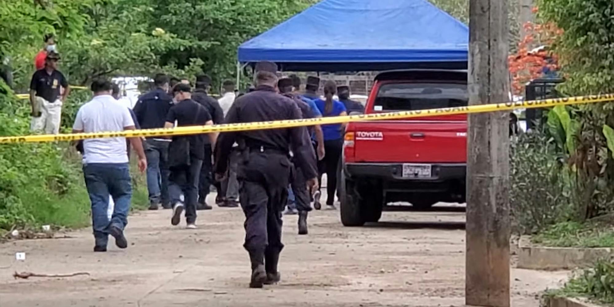 police walk behind police tape