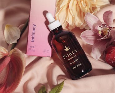 foria's cbd sex oil lube on a bed of flowers