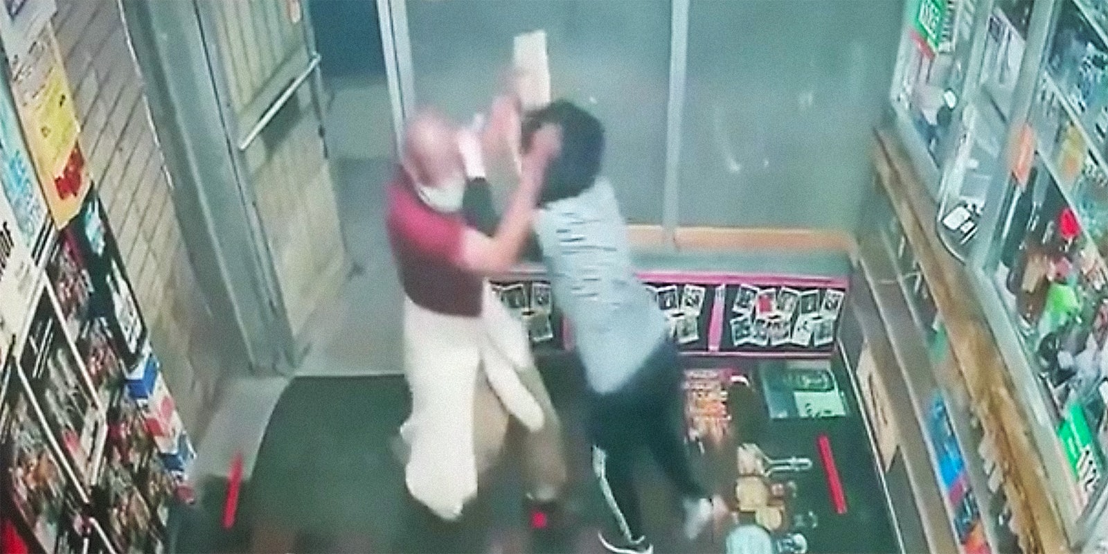 A man attacking a woman with a cement block.