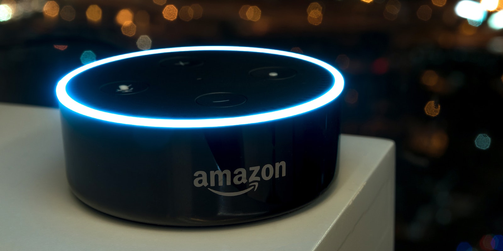 An Amazon Echo dot version 2 on a white table.