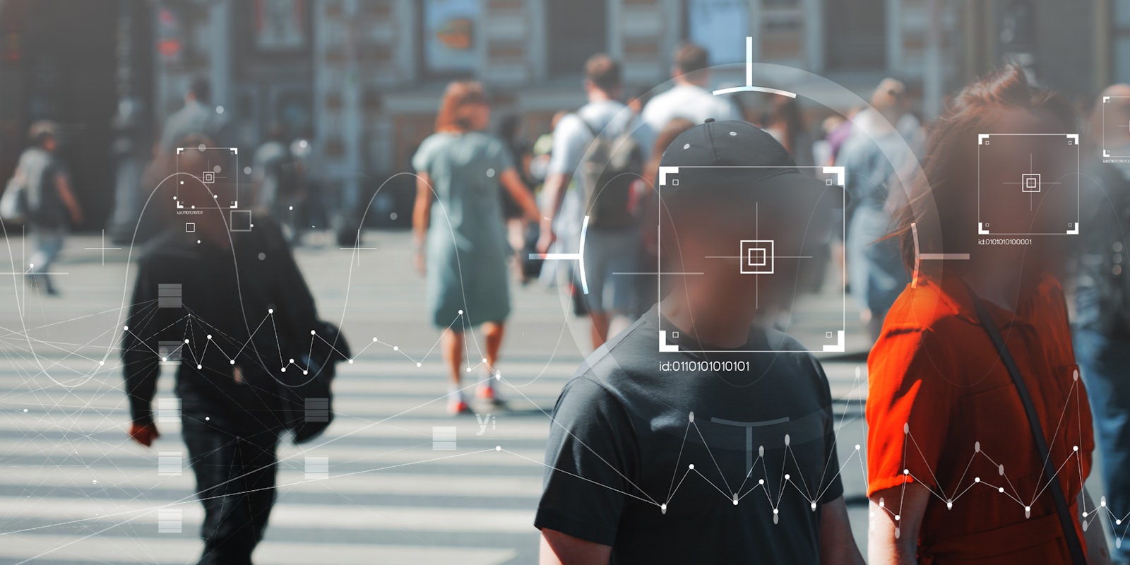 People walking on a street. Their faces are blurred and facial recognition technology is being used on them.