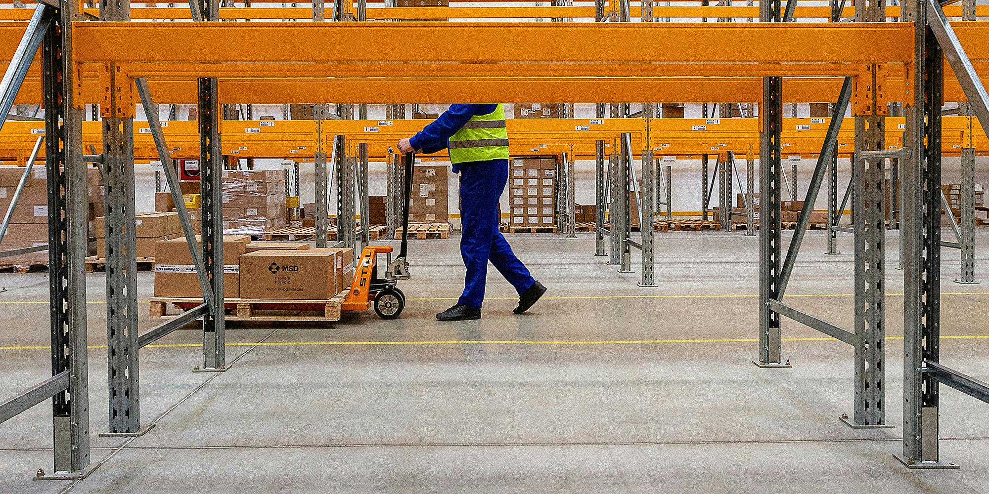 A man walking in a warehouse.