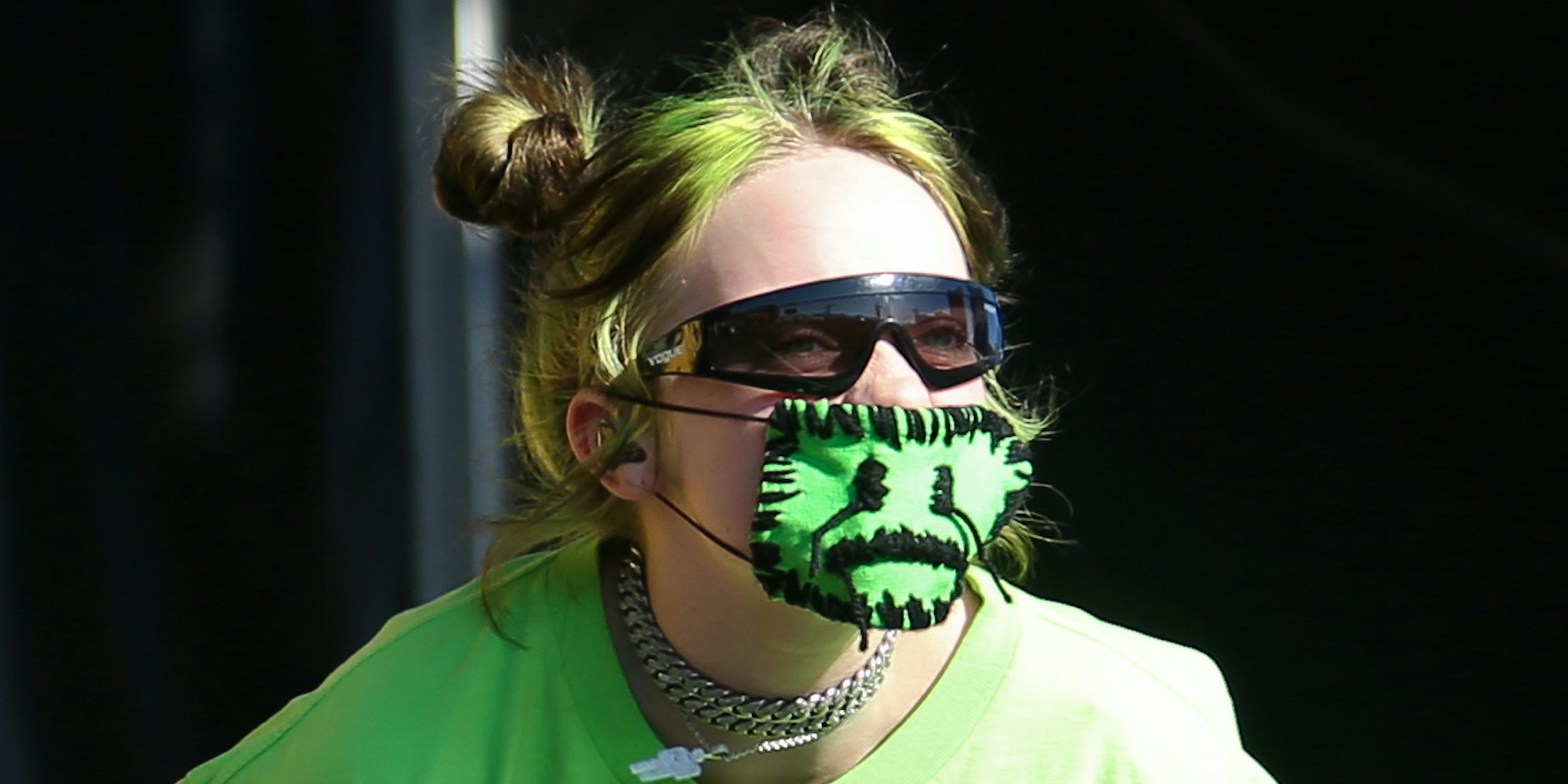 Billie Eilish wearing green facemask