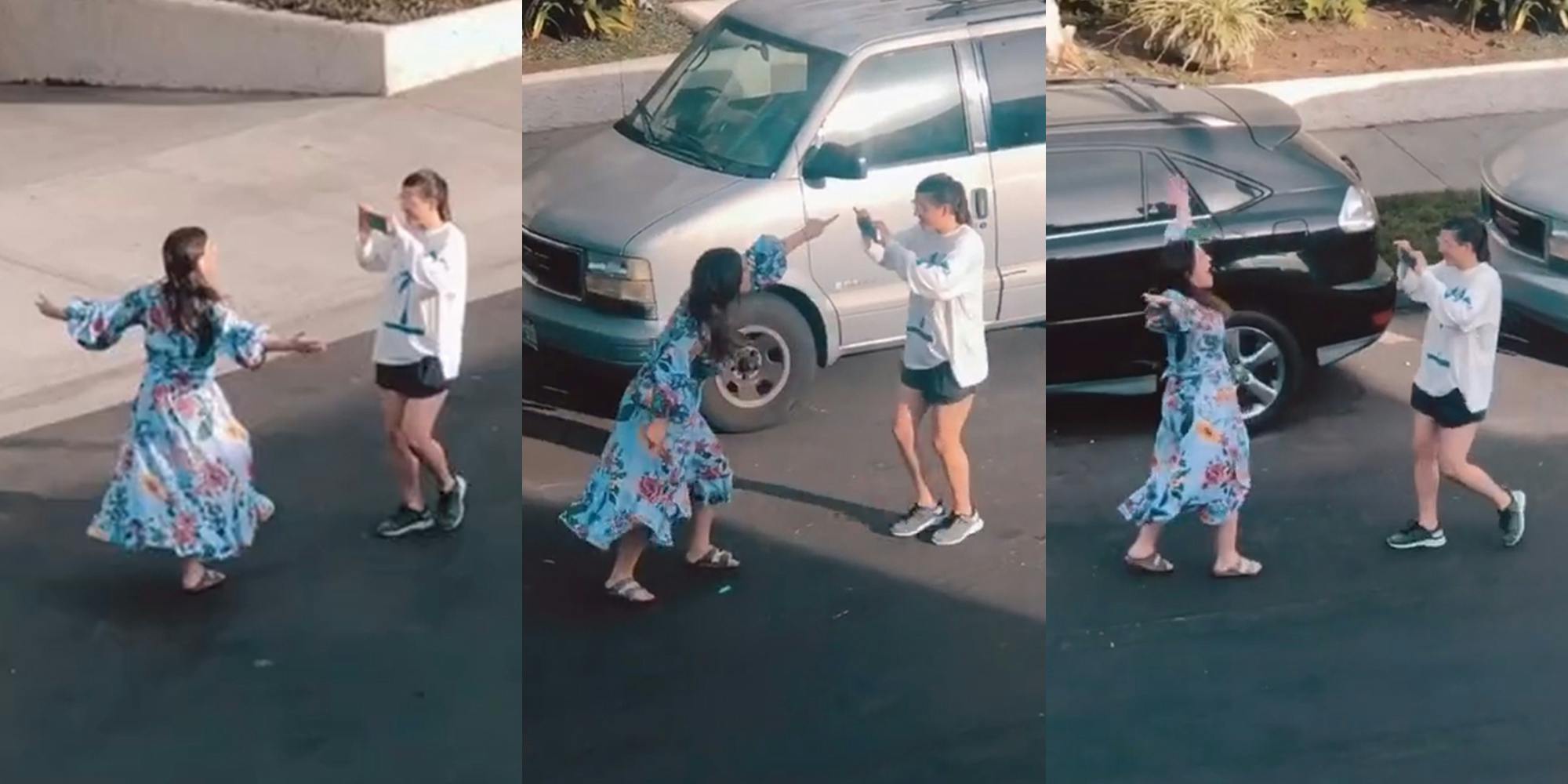 young woman in dress singing in street while a friend films